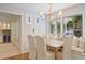 Bright dining room featuring window seating, a modern chandelier, and a view into the kitchen at 2567 Hyde Manor Nw Dr, Atlanta, GA 30327