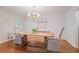 Bright dining room featuring hardwood floors and a farmhouse-style table at 2567 Hyde Manor Nw Dr, Atlanta, GA 30327