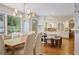 Elegant dining area with a chandelier and view of the modern, white kitchen at 2567 Hyde Manor Nw Dr, Atlanta, GA 30327