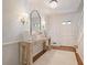 Elegant entryway with a wooden console table, decorative mirror, and stylish lighting fixtures at 2567 Hyde Manor Nw Dr, Atlanta, GA 30327