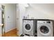 Well-lit laundry room with side-by-side washer and dryer, plus storage above at 2567 Hyde Manor Nw Dr, Atlanta, GA 30327
