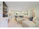 Comfortable living room with a brick fireplace, built-in bar, and French doors to sunroom at 2567 Hyde Manor Nw Dr, Atlanta, GA 30327