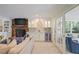 Inviting living room with a bar area, a brick fireplace, and access to a sunroom at 2567 Hyde Manor Nw Dr, Atlanta, GA 30327