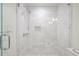 Luxurious walk-in shower featuring white marble tile, rainfall shower head, and sleek glass enclosure at 2567 Hyde Manor Nw Dr, Atlanta, GA 30327