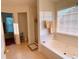 Bright bathroom featuring a soaking tub, tile flooring, and natural light from large windows at 385 Bethesda Park Trl, Lawrenceville, GA 30044
