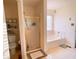 Well-equipped bathroom with a separate shower, soaking tub, and modern fixtures at 385 Bethesda Park Trl, Lawrenceville, GA 30044