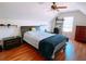 Attic bedroom featuring hardwood floors, a sloped ceiling, and a charming window with natural light at 385 Bethesda Park Trl, Lawrenceville, GA 30044
