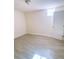 Bright bedroom with wood-look tile flooring and natural light from window at 385 Bethesda Park Trl, Lawrenceville, GA 30044
