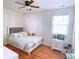 Charming bedroom with hardwood floors, a plush bed, a ceiling fan, and a bright window at 385 Bethesda Park Trl, Lawrenceville, GA 30044