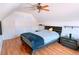 Attic bedroom with a sloped ceiling, hardwood floors, and comfortable bedding with a ceiling fan at 385 Bethesda Park Trl, Lawrenceville, GA 30044