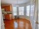 Sunlit breakfast nook with a bay window, hardwood floors, and matching trash cans at 385 Bethesda Park Trl, Lawrenceville, GA 30044