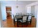 Dining room with a modern light fixture, adjacent to the kitchen, and hardwood floors at 385 Bethesda Park Trl, Lawrenceville, GA 30044