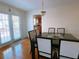 Dining room with hardwood floors, modern light fixture, and access to the backyard at 385 Bethesda Park Trl, Lawrenceville, GA 30044