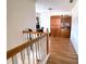 Upstairs hallway featuring hardwood floors and a built in bookshelf in the adjacent room at 385 Bethesda Park Trl, Lawrenceville, GA 30044