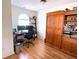 Functional home office featuring hardwood floors, built-in shelving, and a large arched window for ample natural light at 385 Bethesda Park Trl, Lawrenceville, GA 30044
