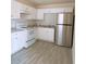 Kitchen features white cabinets, stainless refrigerator, and hard surface countertops at 385 Bethesda Park Trl, Lawrenceville, GA 30044