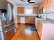 Kitchen with stainless steel appliances, granite countertops, wood cabinets, and hardwood floors at 385 Bethesda Park Trl, Lawrenceville, GA 30044
