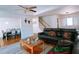 Open concept living room with hardwood floors, black sectional couch, and staircase at 385 Bethesda Park Trl, Lawrenceville, GA 30044