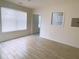 Bright living room with wood-look tile flooring and kitchen window at 385 Bethesda Park Trl, Lawrenceville, GA 30044