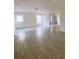 Bright living room showcasing wood-look tile flooring and ample natural light at 385 Bethesda Park Trl, Lawrenceville, GA 30044