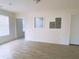 Bright living room showcasing wood-look tile flooring and window into kitchen at 385 Bethesda Park Trl, Lawrenceville, GA 30044