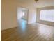 Bright living room with wood-look tile flooring and adjoining room view at 385 Bethesda Park Trl, Lawrenceville, GA 30044