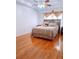 Comfortable main bedroom with a wooden headboard, neutral tones, and hardwood flooring at 385 Bethesda Park Trl, Lawrenceville, GA 30044