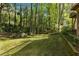 Large backyard area with mature trees and manicured lawn at 4462 Cain Cir, Tucker, GA 30084