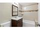 Neat bathroom featuring a vanity with storage, tiled walls, and a shower-tub combination at 4462 Cain Cir, Tucker, GA 30084