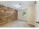 Bedroom featuring a brick accent wall and view of the yard from the window at 4462 Cain Cir, Tucker, GA 30084