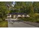 Charming single-story home with a well-maintained lawn, mature trees, and a long driveway at 4462 Cain Cir, Tucker, GA 30084
