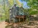 View of the back exterior, showcasing a wooden deck perfect for outdoor dining and entertaining at 5876 Bridgemont Nw Pl, Acworth, GA 30101