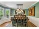 Stylish dining room with elegant lighting, decorative wall decor, and a view to the outdoors at 5876 Bridgemont Nw Pl, Acworth, GA 30101