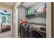 Modern laundry room with updated machines and ample storage shelves at 5876 Bridgemont Nw Pl, Acworth, GA 30101