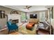 Cozy living room with fireplace, large windows, and hardwood floors at 5876 Bridgemont Nw Pl, Acworth, GA 30101