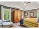 Serene bedroom with vaulted ceiling, large windows and a decorative armoire at 5876 Bridgemont Nw Pl, Acworth, GA 30101