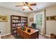 Cozy office space with a large desk, bookshelf, and natural light at 5876 Bridgemont Nw Pl, Acworth, GA 30101