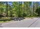Street view of property with mature trees lining the roadway at 5876 Bridgemont Nw Pl, Acworth, GA 30101