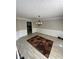 Elegant dining area with stylish lighting, neutral walls, and a patterned rug creating a cozy atmosphere at 1086 Deshon Trl, Lithonia, GA 30058