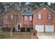 Charming two-story brick home with a well-manicured lawn and red shutters at 1086 Deshon Trl, Lithonia, GA 30058
