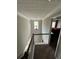 View of a hallway with dark wooden rails and an open window with a transom window at 1086 Deshon Trl, Lithonia, GA 30058
