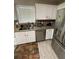 Bright kitchen with granite countertops, white cabinets, and stainless steel appliances at 1086 Deshon Trl, Lithonia, GA 30058