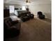 Spacious main bedroom featuring neutral walls, fan, sitting area, and a plush carpet at 1086 Deshon Trl, Lithonia, GA 30058