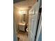 Cozy powder room with a pedestal sink and neutral walls at 1086 Deshon Trl, Lithonia, GA 30058