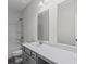 Well-lit bathroom featuring double mirrors, gray vanity and a combination tub and shower at 529 Lanier Way, Temple, GA 30179