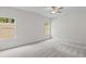 Bright bedroom features large windows, neutral walls, ceiling fan, and soft gray carpeting at 529 Lanier Way, Temple, GA 30179