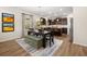 Open dining area with modern lighting, large windows, contemporary art, and hardwood flooring at 529 Lanier Way, Temple, GA 30179