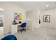Bright hallway featuring a built-in desk, comfortable blue chair, and stylish modern decor and artwork at 529 Lanier Way, Temple, GA 30179