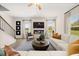 Comfortable living room offers a fireplace, large windows, ceiling fan, and hardwood flooring at 529 Lanier Way, Temple, GA 30179