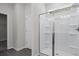 A bright bathroom with a glass-enclosed shower, featuring built-in shelving and a window for natural light at 529 Lanier Way, Temple, GA 30179